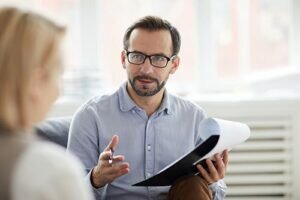 BRC Healthcare health professional talks to patient about accreditations