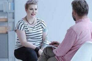 a person talks to a therapist in one of many successful addiction treatment programs