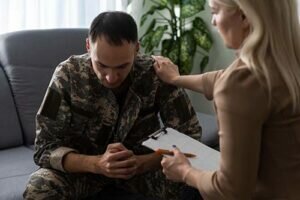 a veteran is comforted by a therapist during addiction treatment for veterans