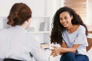 a person talks to a therapist during cognitive-behavioral therapy