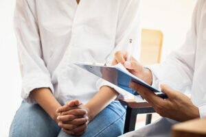 a doctor conducts an addiction evaluation with a client