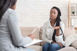 a person talks to a therapist in a residential addiction treatment center